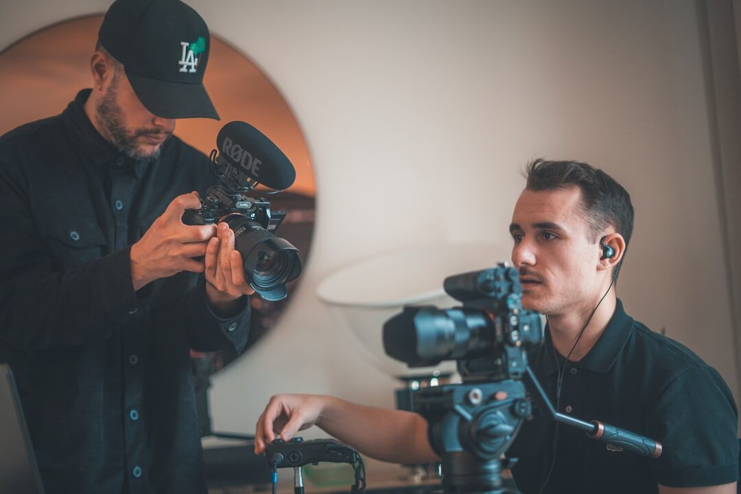 Two journalists coordinating a live interview setup with equipment