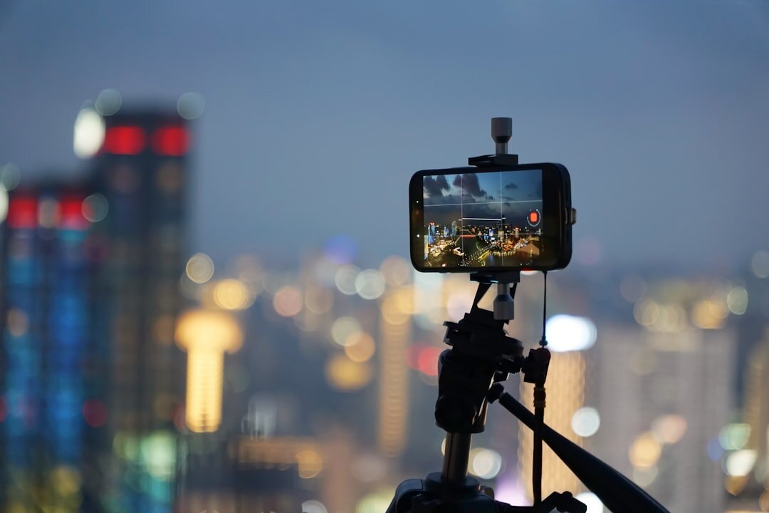 Smartphone mounted on a gimbal stabilizer filming a city scene
