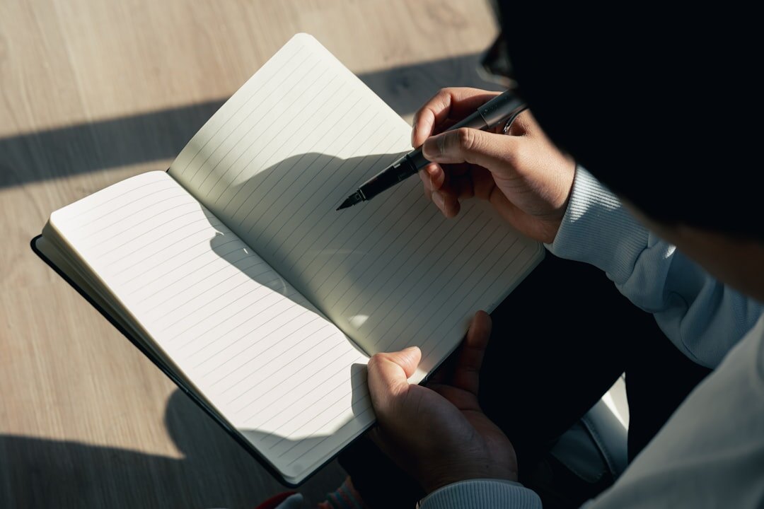 Journalist writing notes and planning a reportage on a notebook