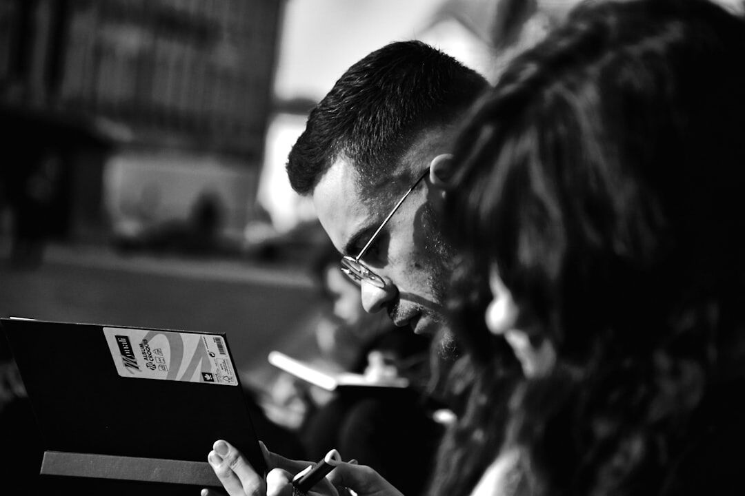 Team of journalists reviewing footage on a laptop in a newsroom