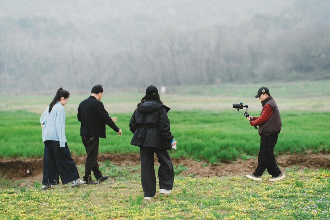 Group of trainees practicing mobile filming techniques outdoors